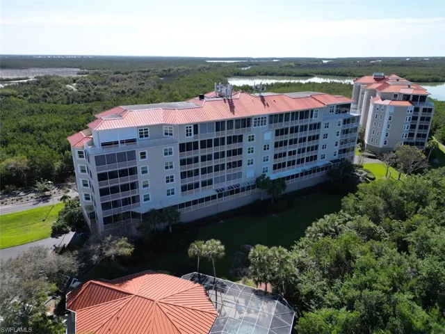 Aerial view of apartment complex / building and a nearby body of water