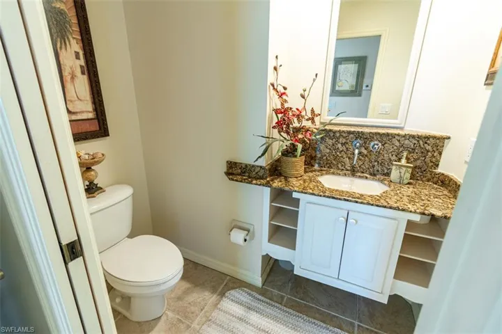 Bathroom with vanity and tasteful backsplash