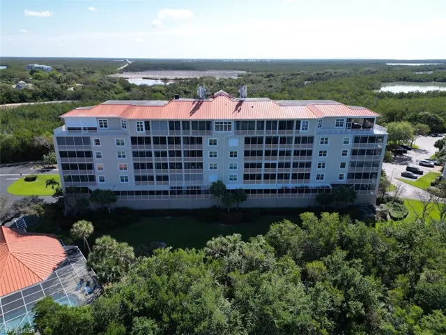 Aerial view of apartment complex / building and a large body of water