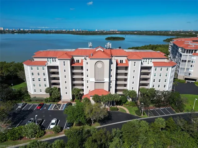 Drone / aerial view of apartment complex / building and a large body of water