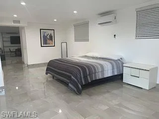 Bedroom featuring light tile patterned floors and recessed lighting