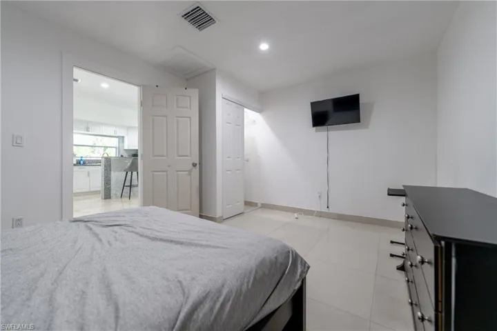 Bedroom with recessed lighting and light tile patterned flooring