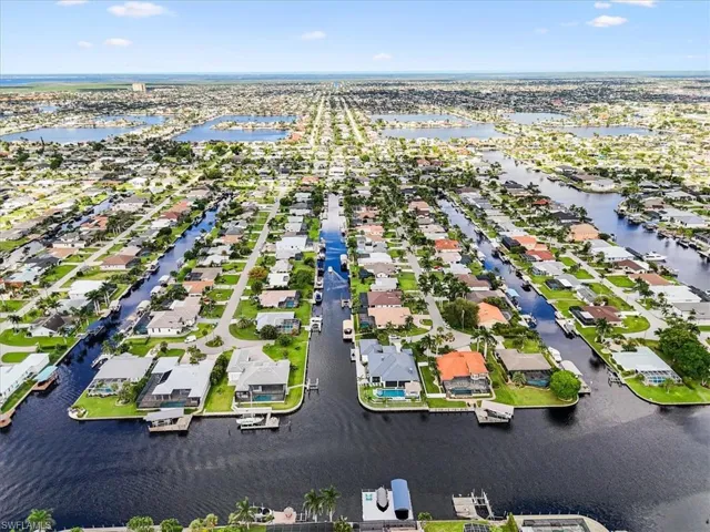 Aerial view of residential area featuring a nearby body of water