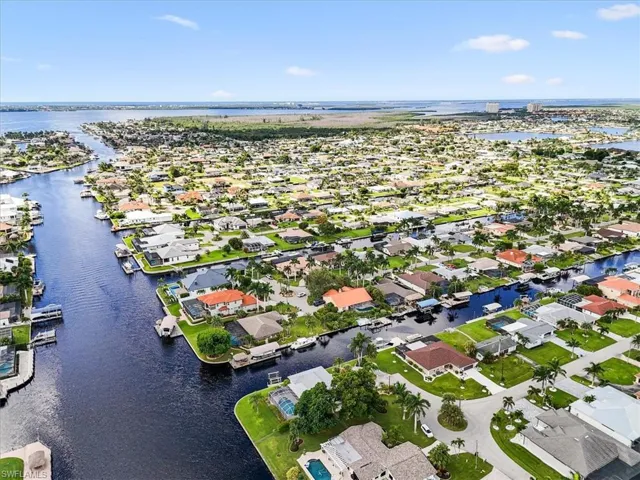 Aerial perspective of suburban area with a nearby body of water