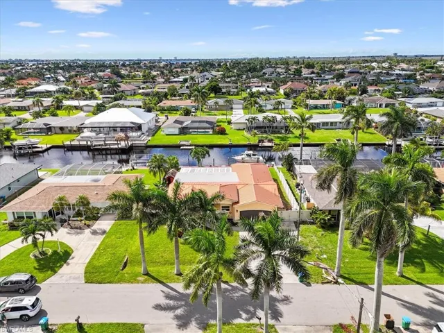 Aerial perspective of suburban area featuring a large body of water