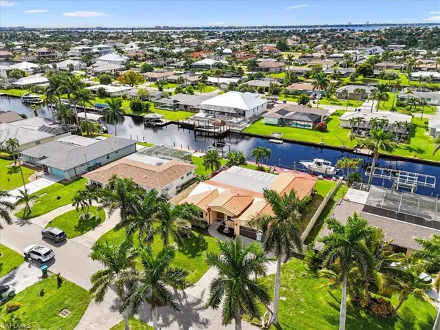 Aerial view of residential area featuring a large body of water