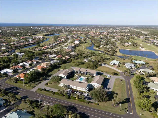 Birds eye view of property with a water view