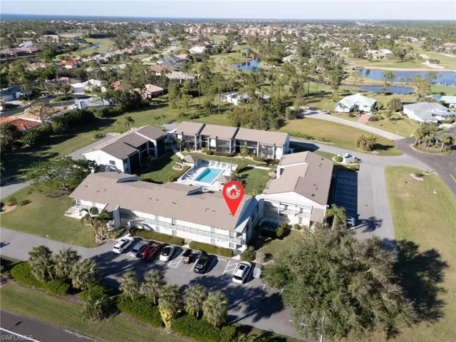 Birds eye view of property with a water view
