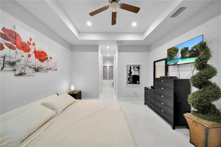 Bedroom with ceiling fan and ensuite bathroom