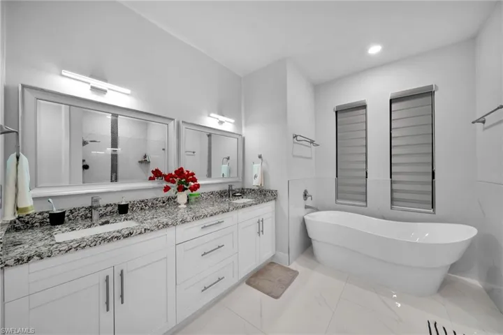 Bathroom featuring independent shower and bath and vanity
