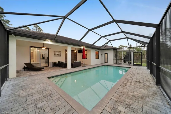 View of pool featuring a patio, a lanai, and ceiling fan