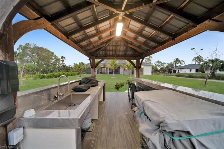 View of patio / terrace featuring a gazebo, grilling area, and an outdoor wet bar