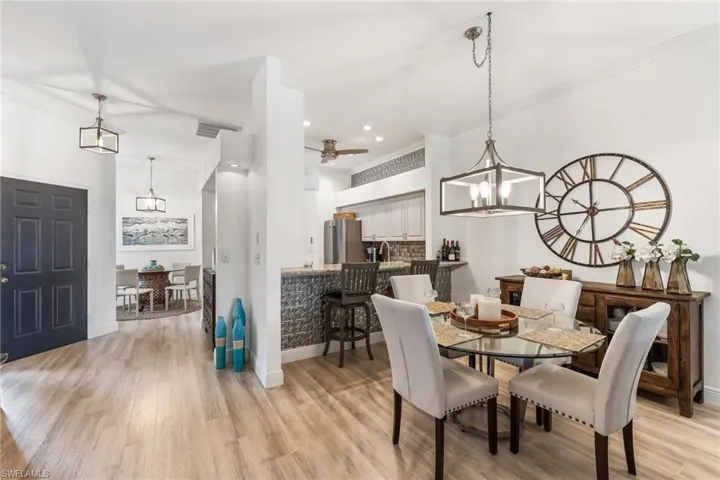 Front to dining bar to kitchen luxury vinyl great new light fixtures detail bar and above sofit