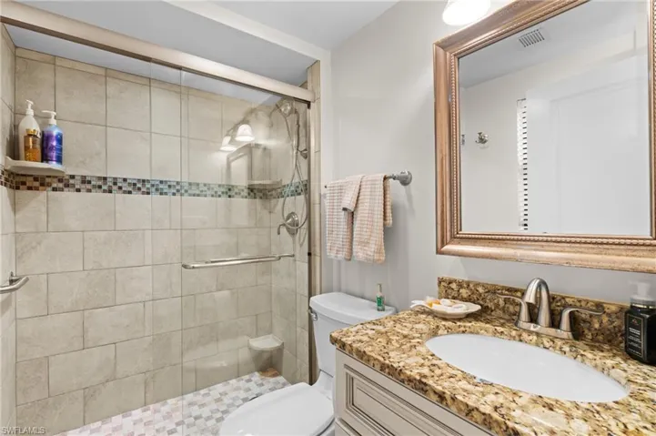 Bathroom featuring vanity and a stall shower