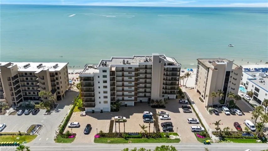 Aerial view of apartment complex / building and a nearby body of water