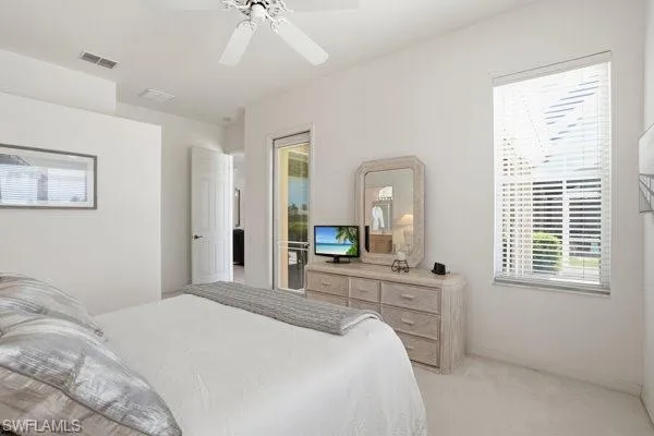 Primary Bedroom with En Suite.  Door to the Lanai/Pool