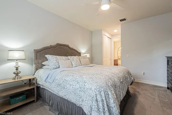 Carpeted bedroom featuring baseboards and a ceiling fan