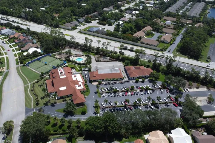 Aerial view of property and surrounding area featuring nearby suburban area