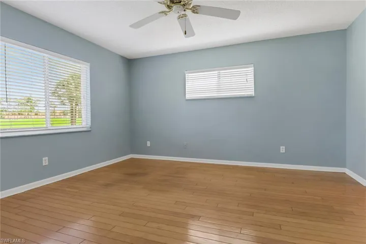 Spare room with healthy amount of natural light, ceiling fan, light wood-type flooring, and a textured ceiling