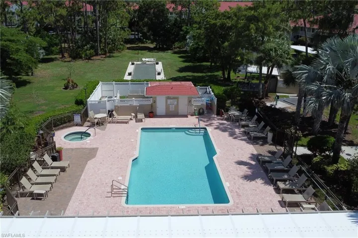 Community pool featuring a hot tub and a patio area