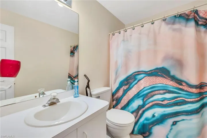 Bathroom featuring vanity and curtained shower