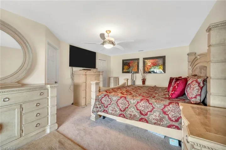 Bedroom featuring light carpet and a ceiling fan