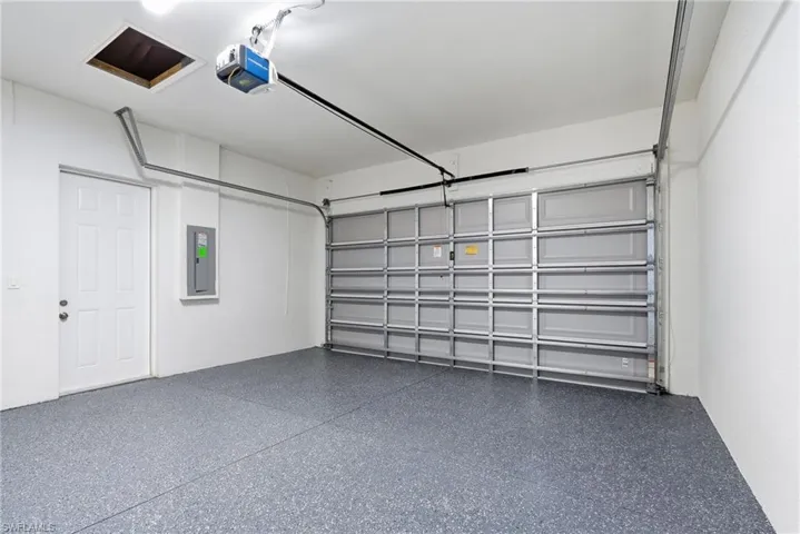 Garage with a garage door opener and electric panel