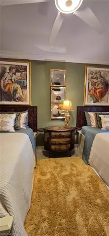 Bedroom featuring ceiling fan and crown molding