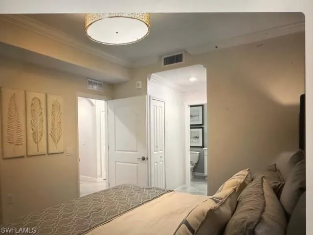 Bathroom featuring vanity, toilet, and crown molding