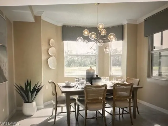 Dining area with ornamental molding, a wealth of natural light, and an inviting chandelier