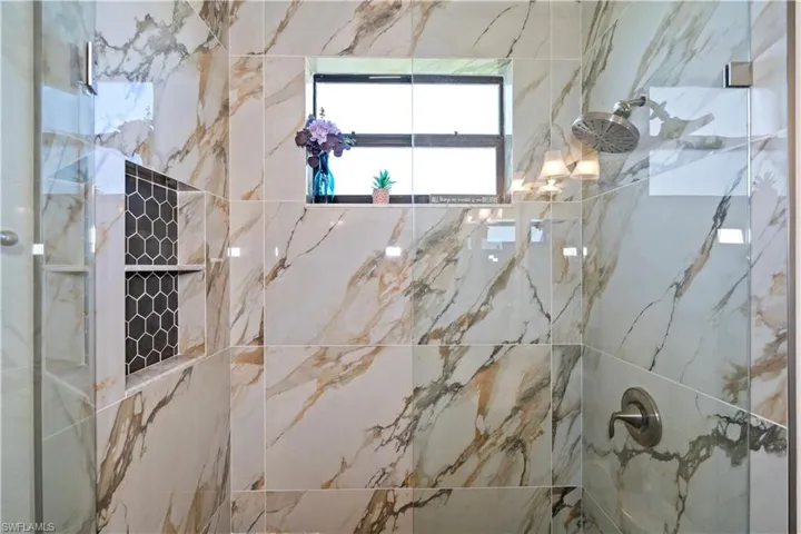 Bathroom featuring a marble finish shower