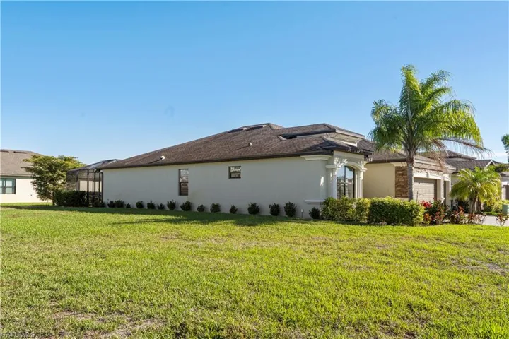 View of home's exterior with stucco siding and a lawn