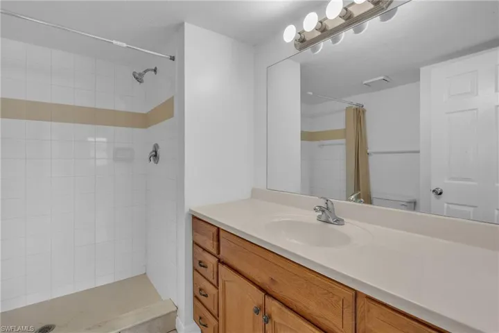Full bathroom featuring vanity and a tile shower
