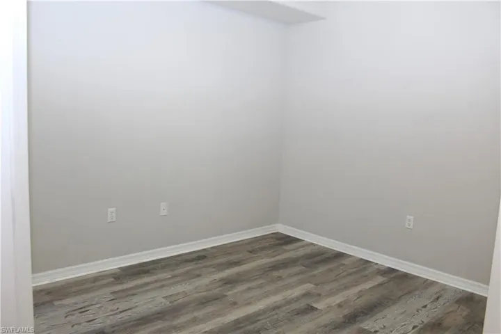 Empty room featuring wood-type flooring