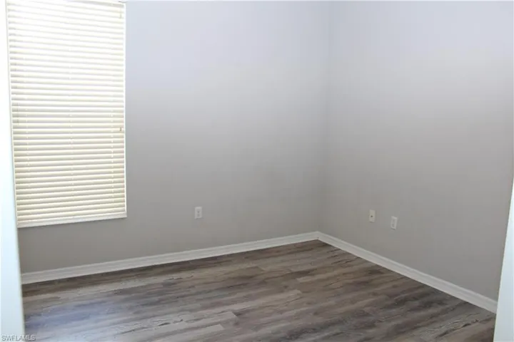 Empty room with hardwood / wood-style flooring