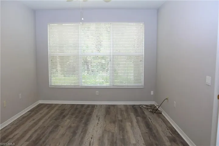 Unfurnished room featuring ceiling fan and hardwood / wood-style floors