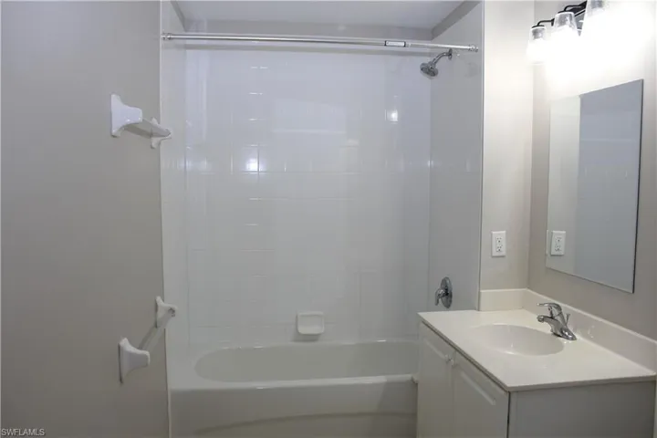 Bathroom with vanity and tiled shower / bath