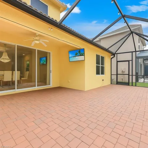 View of patio / terrace with a sunroom, a ceiling fan, and a lanai
