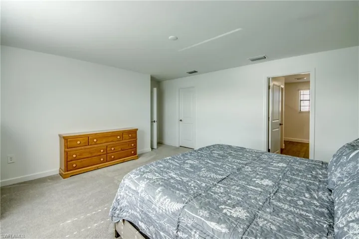 Carpeted bedroom featuring baseboards