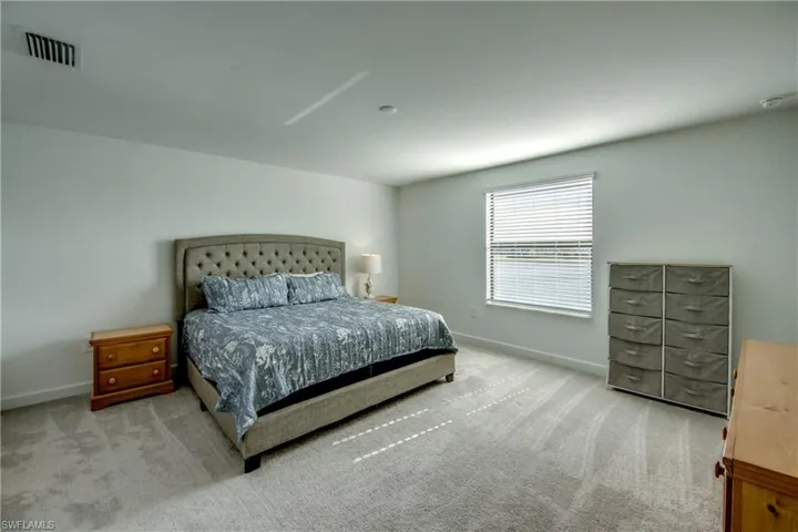 Bedroom featuring baseboards and carpet