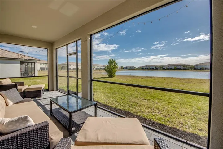 Sunroom / solarium featuring an outdoor living space, a residential view, and a water view