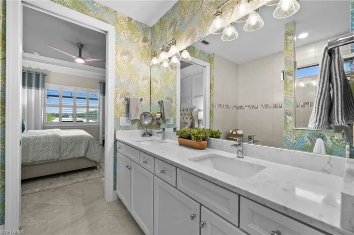 Bathroom with ceiling fan, tile patterned flooring, and vanity