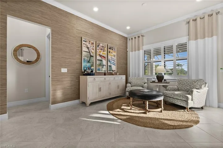 Sitting room featuring light tile patterned floors and crown molding