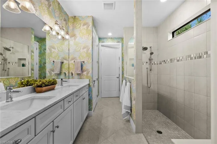 Bathroom with a tile shower and vanity