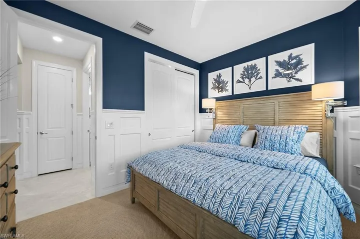 Carpeted bedroom with a closet and ceiling fan