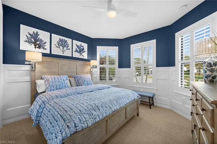 Carpeted bedroom with ceiling fan