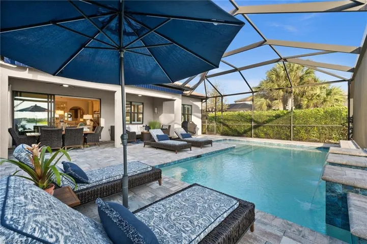 View of swimming pool featuring outdoor lounge area, a patio, and a lanai