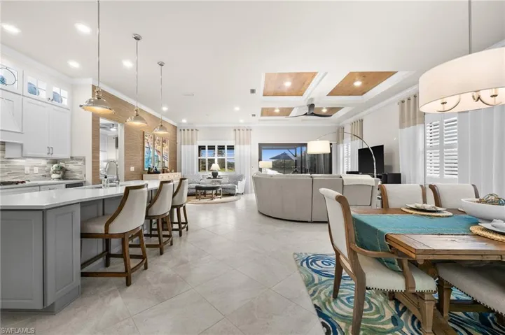 Dining area with crown molding, plenty of natural light, beamed ceiling, and coffered ceiling