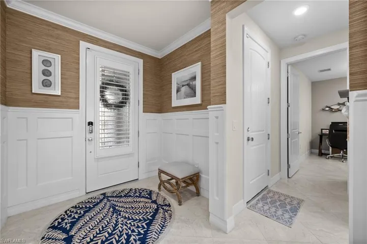Foyer featuring ornamental molding