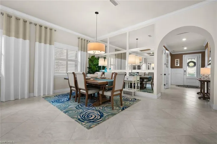 Tiled dining area with crown molding